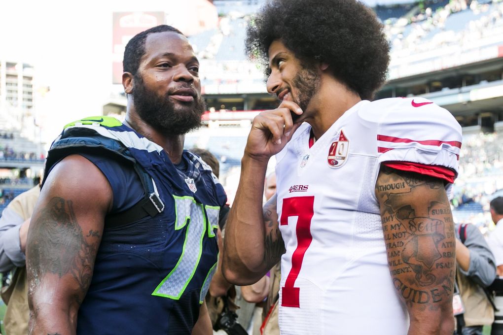 San Francisco 49ers quarterback Colin Kaepernick talks with Seahawks defensive end Michael Bennett after a game Sept. 25, 2016. (Bettina Hansen / The Seattle Times)