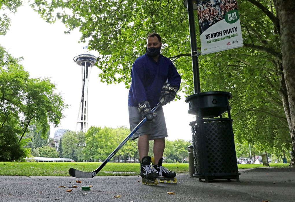 Local hockey fan Mark Siano was so excited for the announcment of Seattle NHL’s team, he showed up at Seattle Center with his stick on Thursday. Siano said when growing up in the area, he never thought this day would come. (Ken Lambert / The Seattle Times)