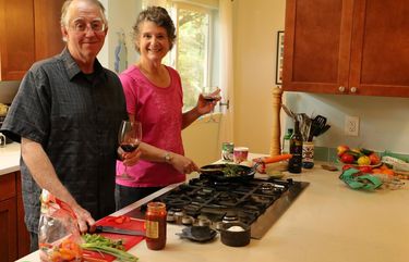 Steve Venard and Cathy Martin, pictured here in their kitchen in Shoreline, enjoy making up new dishes. The catch? They never cook with recipes, choosing instead to make everything up as they go along. So it’s always difficult for them to recreate their dishes exactly.