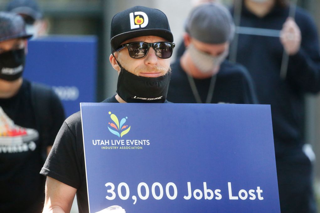 Special events workers who were forced out of work because of the COVID-19 pandemic marched Tuesday, July 21, 2020, in Salt Lake City. Marchers organized by Utah Live Event Industry Association aimed to draw attention and legislative support to the people and businesses who put on concerts, theater, sports, and other live events which mostly have gone dark since the COVID-19 pandemic hit in March. They’re called it a “peaceful walk for work.” The silent parade showcased families struggling to make ends meet since events have been canceled, with no end to the restrictions in sight. (AP Photo/Rick Bowmer)