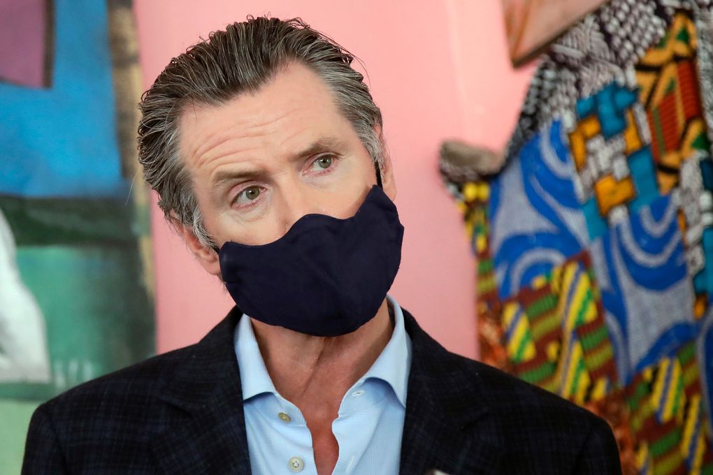 California Gov. Gavin Newsom wears a mask while speaking to reporters in Oakland. According to a new poll, Americans overwhelmingly are in favor of requiring people to wear masks around other people outside their homes, reflecting fresh alarm over spiking coronavirus infection rates. (AP Photo/Jeff Chiu, pool, file)