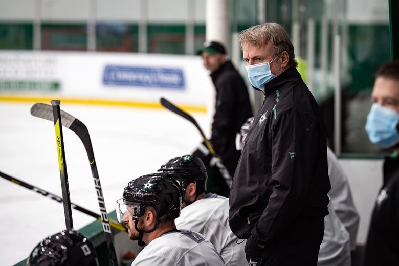 Dallas Stars coach Rick Bowness reacts to clips of his old