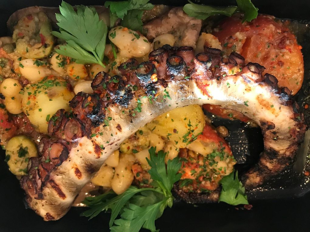 The braised octopus at RockCreek Seafood & Spirits is finished over an applewood grill and fortified with fingerling potatoes, briny olives, roasted acidic tomato, cannellini beans and aioli. (Tan Vinh)