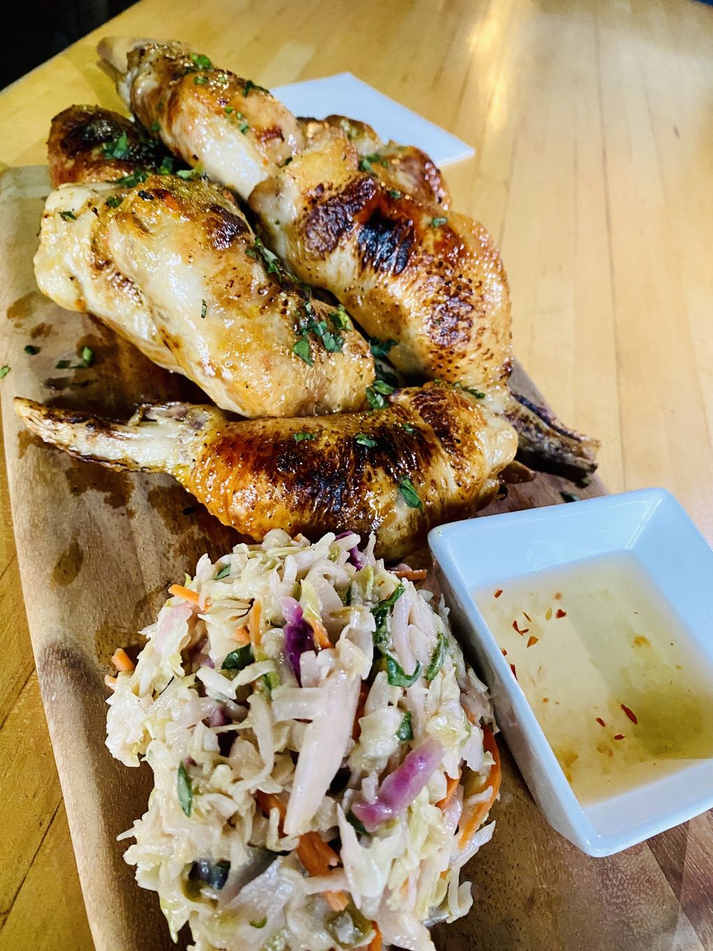 Not your usual chicken wings. Oliver’s Twist does a boneless and stuffed version with a side of slaw tossed with coconut and scallion dressing. (Courtesy of Oliver’s Twist)