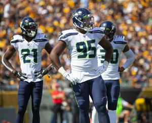 Seattle Seahawks wide receivers John Ursua (15) and Gary Jennings (11)  watch drills on the first