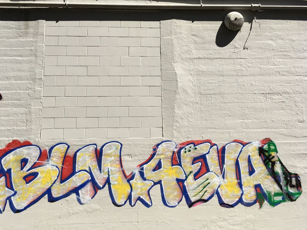 Graffiti on the Seattle Police Department’s East Precinct building left over from CHOP (the Capitol Hill Organized Protest). After ending CHOP’s 22-day occupation, the city painted over most of the graffiti on public property — but let some remain. (Brendan Kiley / The Seattle Times)