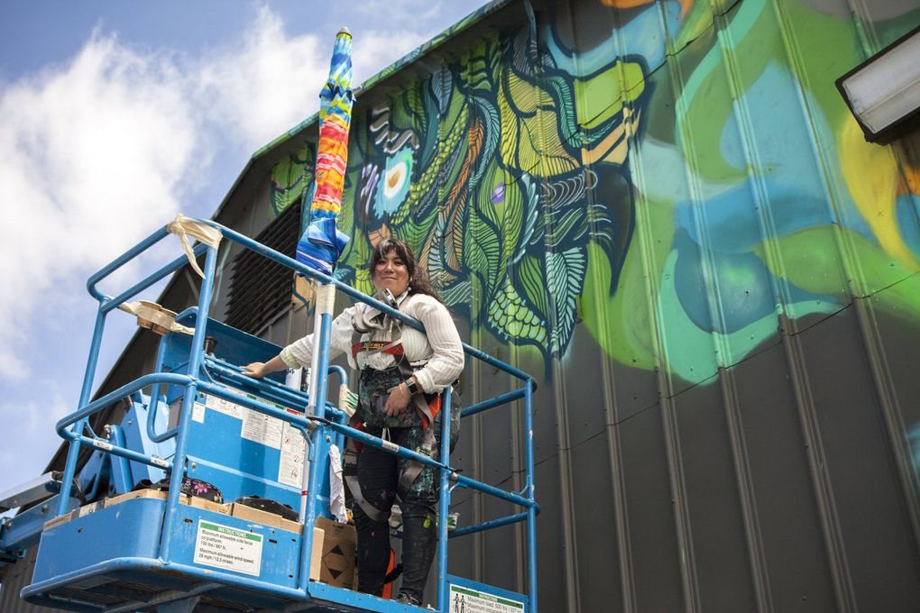 Graffiti artist Angelina Villalobos, also known as 179, works on her mural for SODO Track in 2018. (Courtesy of Wiseknave)