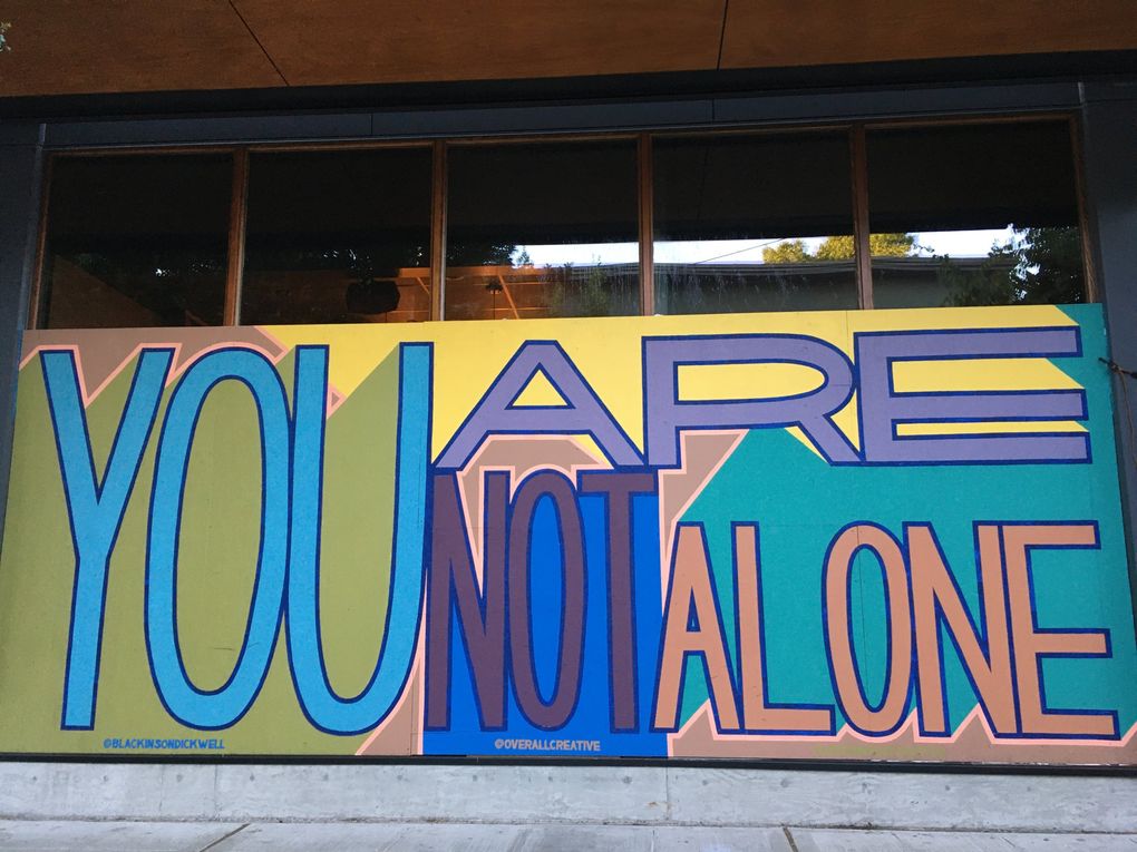 “You Are Not Alone,” a COVID-plywood mural for the Capitol Hill bar Life on Mars, is one of Ezra Dickinson’s more accessible works. His other paintings and stickers can be more abstract, and often hidden in difficult-to-find places only a few people will accidentally find. (Brendan Kiley / The Seattle Times)