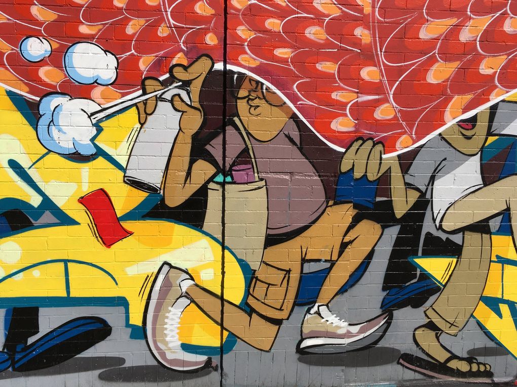 Seattle graffiti artist Sneke painted a small self-portrait in a detail of his mural, at 12th Avenue South and South Jackson Street in the Chinatown International District, made with Geneva-born artist Tones. (Brendan Kiley / The Seattle Times)