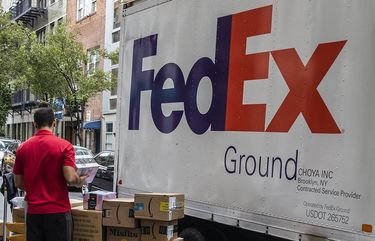 **EMBARGO: No electronic distribution, Web posting or street sales before Sunday at 3:01 a.m. ET, Nov. 17, 2019. No exceptions for any reasons. EMBARGO set by source.** FILE — A FedEx truck drives around workers sorting packages on the Upper East Side of Manhattan, Aug. 28, 2019. In the 2017 fiscal year, FedEx owed more than $1.5 billion in taxes. The next year, after President Donald Trump’s tax cut, it owed nothing. And like much of corporate America, the company has not made good on its promised investment surge. (Brittainy Newman/The New York Times) XNYT116