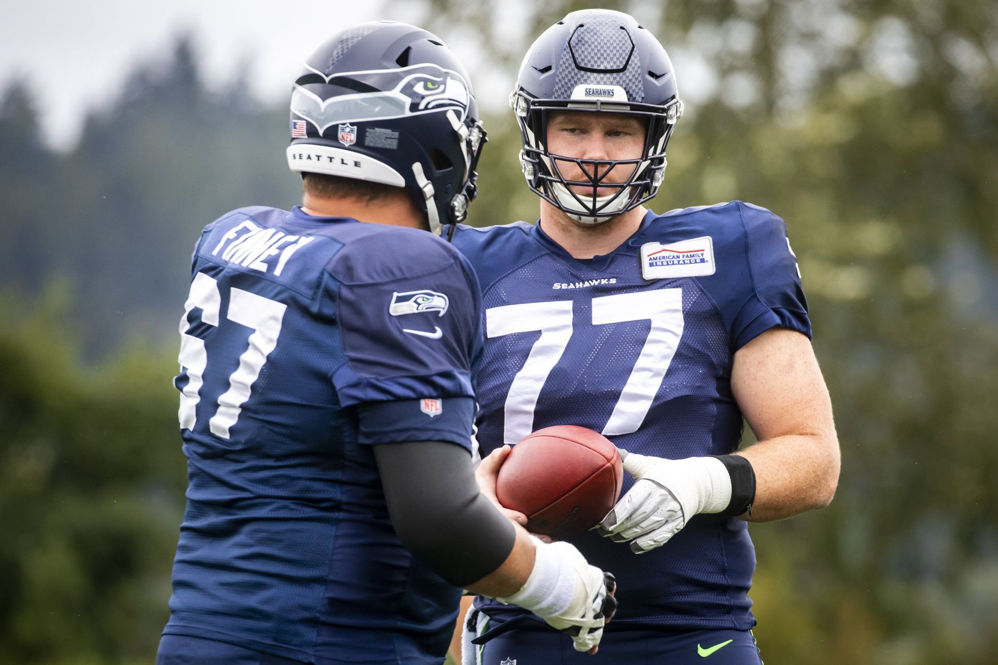 Seahawks give right guard Damien Lewis a surprise start at center for the  first time in his football career