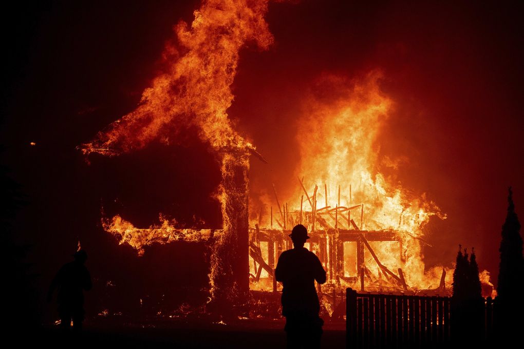 A home burns as the Camp Fire rages through Paradise, Calif., on Thursday, Nov. 8, 2018. Tens of thousands of people fled the fast-moving wildfire in Northern California, some clutching babies and pets as they abandoned vehicles and struck out on foot ahead of the flames that forced the evacuation of an entire town. (AP Photo/Noah Berger)