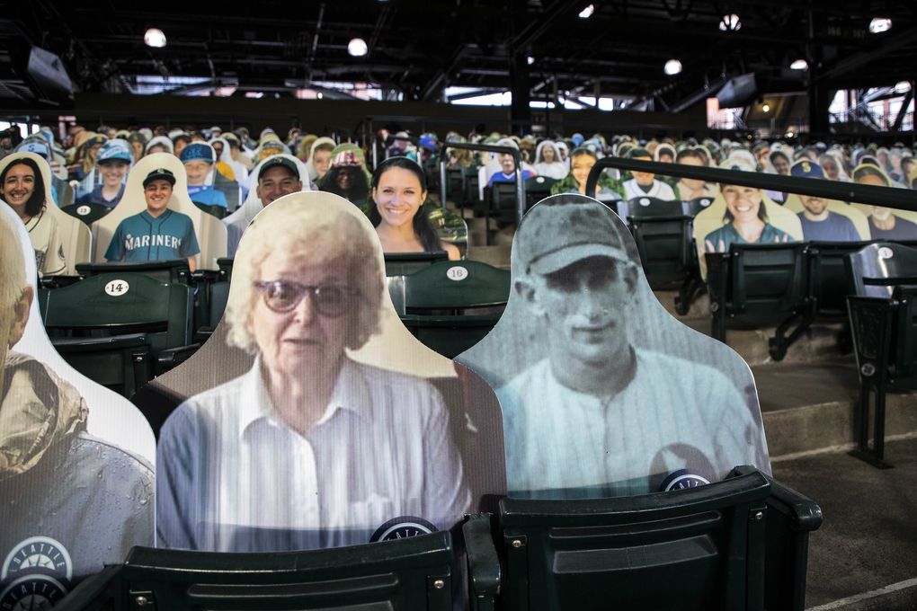 Barbara Losey and her late father, Carl Pritchard, in his baseball uniform are two of the 13,000 cutouts of fans at T-Mobile Park. (Dean Rutz / The Seattle Times)