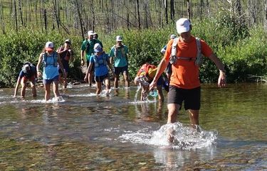 The Ratbob runners ford Youngs Creek roughly 15 miles into the run.  The ice cold water was a reprieve for sore muscles on a day where temperatures approached 90 degrees. (Photo Courtesy Frank Field)