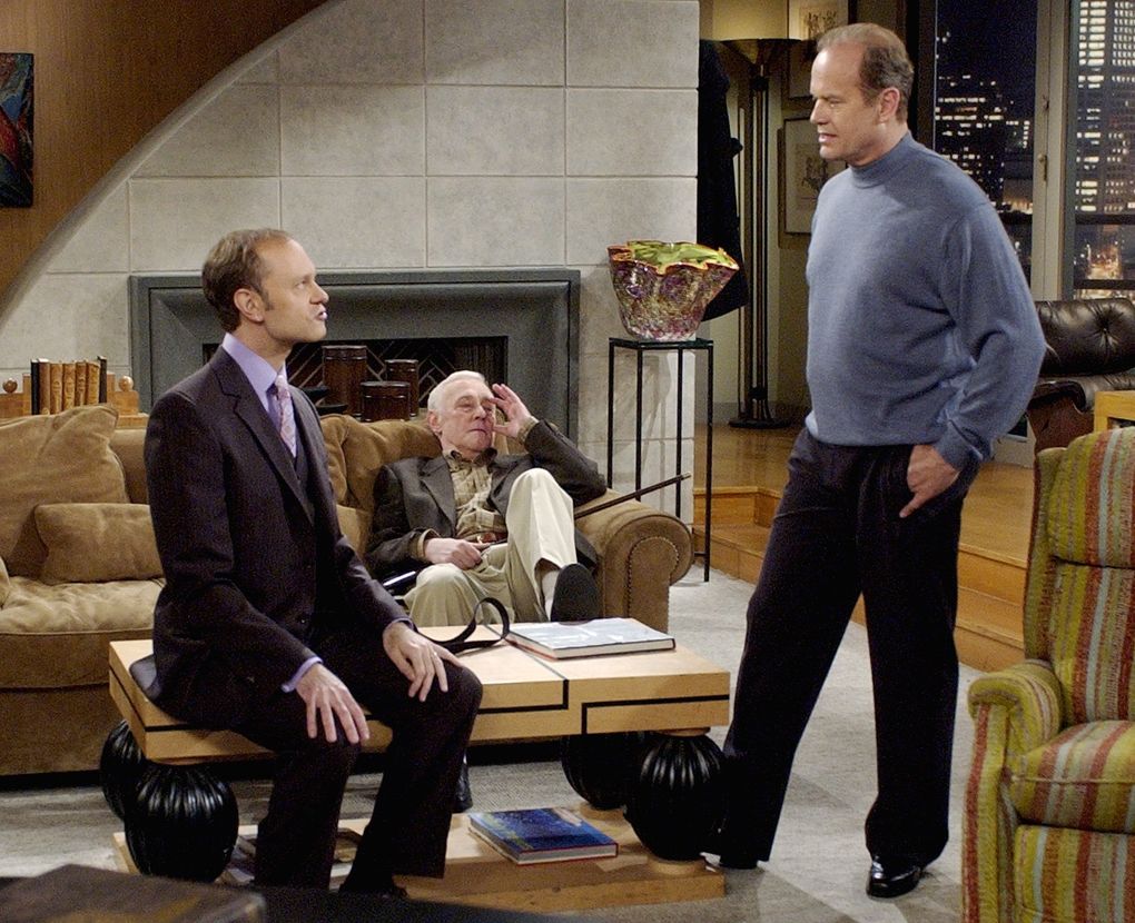 “Frasier” star Kelsey Grammer, right, as Dr. Frasier Crane, talks with co-stars David Hyde Pierce as his brother Niles, left, and John Mahoney during filming of the final episode of the “Cheers” spinoff, which wrapped in 2004 after 11 seasons. (Reed Saxon / The Associated Press, FIle)