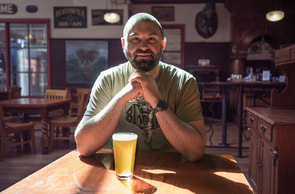 Big Time Brewing owner Rick McLaughlin sits in his University District brewpub on Aug. 26. The brewery is one of many businesses that will be impacted by the cancellation of the UW football season and classes going online. (Steve Ringman / The Seattle Times)