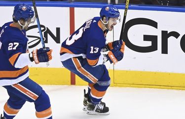New York Islanders center Mathew Barzal (13) celebrates his goal with teammate Anders Lee (27) during the first period of an NHL Stanley Cup Eastern Conference playoff hockey game in Toronto, Ontario, Tuesday, Aug. 18, 2020. (Nathan Denette/The Canadian Press via AP) NSD103