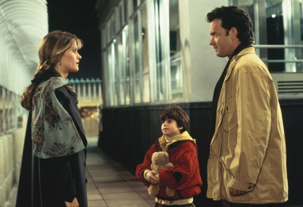 Meg Ryan as Annie Reed, left, Ross Malinger as Jonah Baldwin, center, and Tom Hanks as Sam Baldwin in a scene from “Sleepless in Seattle,” written and directed by Nora Ephron. (1993 TriStar Pictures, Inc. / Associated Press)
