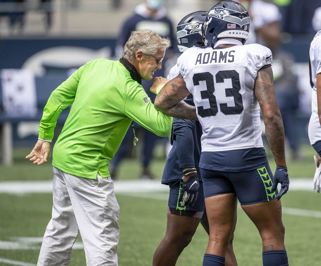 Pete Carroll bumps elbows with Jamal Adams before the team’s scrimmage at CenturyLink Field Saturday, August 22. (Dean Rutz / The Seattle Times)