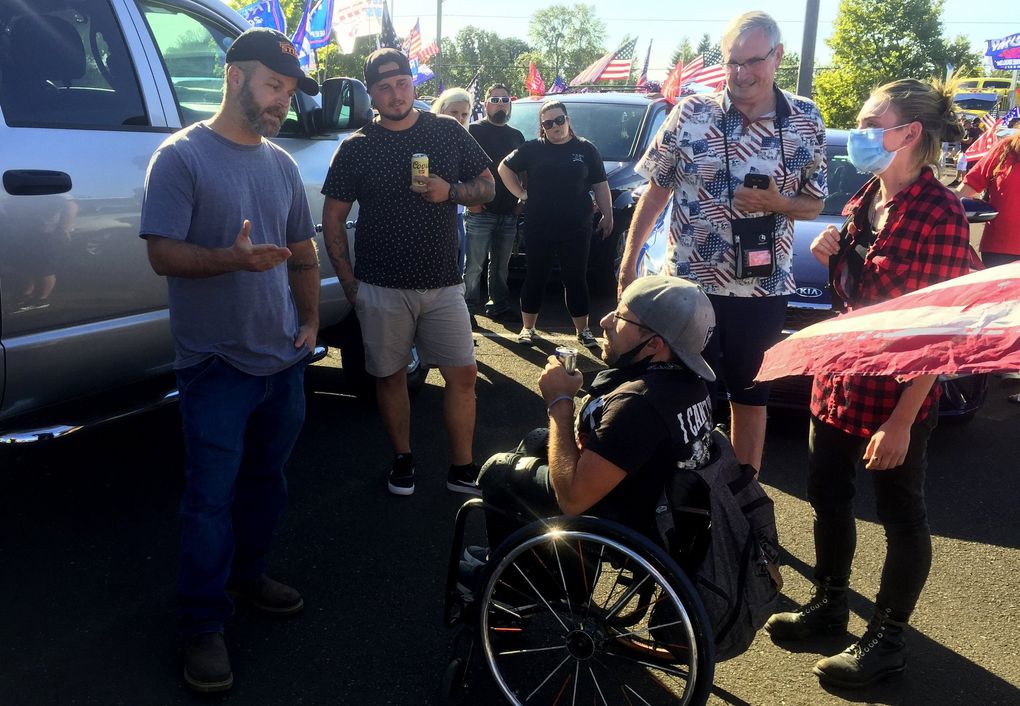 Trump supporters argue with a Black Lives Matter protester (shown in wheelchair). They hold very different views on the state of the nation. They met at a Trump 2020 campaign rally east of Portland on Saturday that drew more than 1,000 people. (Hal Bernton / The Seattle Times)