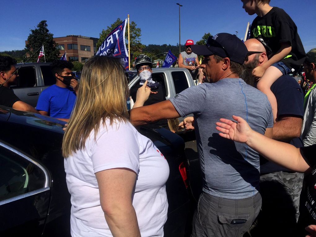 Trump supporters talk with Black Lives Matter supporters in some of the uneasy dialogue that unfolded at the president’s campaign rally at a mall parking lot east of Portland Saturday afternoon. (Hal Bernton / The Seattle Times)