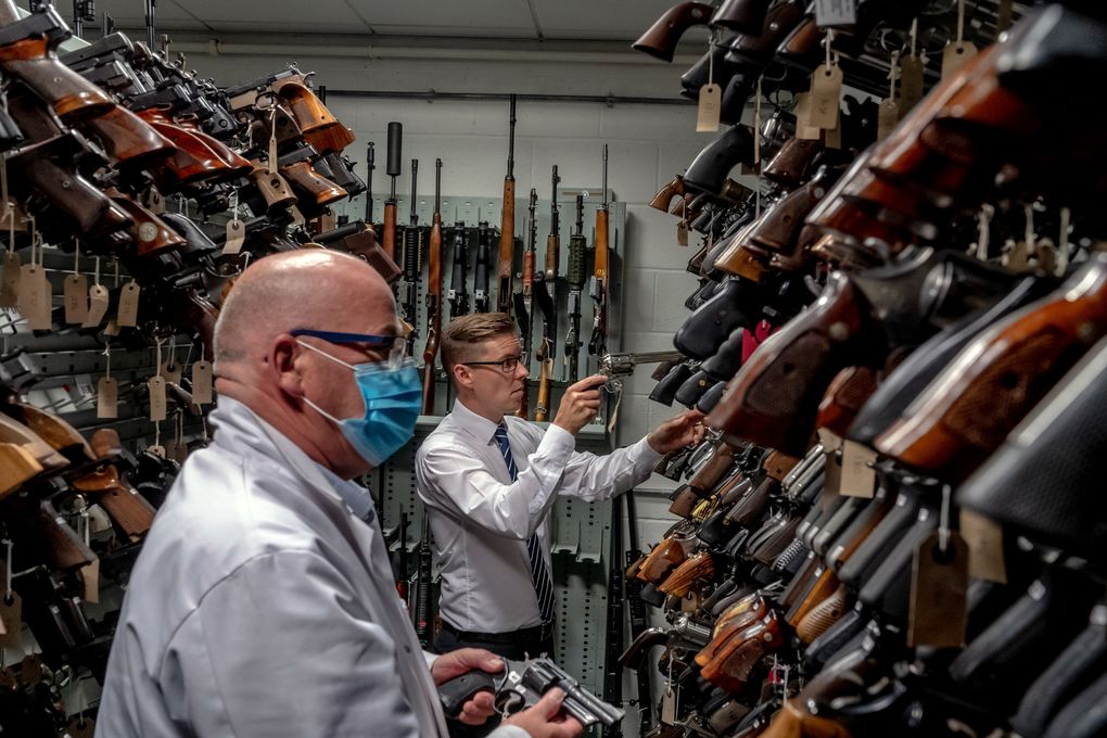 Gregg Taylor, right, at the National Ballistics Intelligence Service in Birmingham, England, on Aug. 6, 2020. Hundreds of illegal guns that officers have seized have come from the United States. (Andrew Testa/The New York Times)