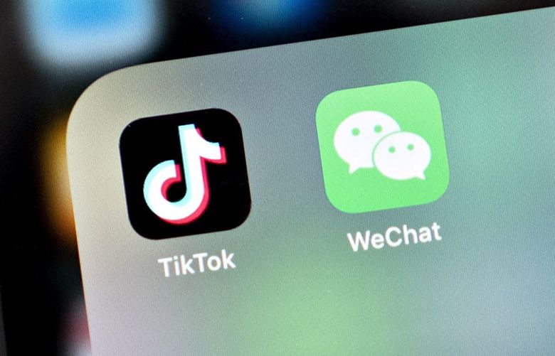 The Tencent Holdings Ltd. WeChat and ByteDance Ltd. TikTok app icons are displayed on a smartphone in an arranged photograph taken in Arlington, Virginia, U.S., on Friday, Aug. 7, 2020. President Donald Trump signed a pair of executive orders prohibiting U.S. residents from doing business with the Chinese-owned TikTok and WeChat apps beginning 45 days from now, citing the national security risk of leaving Americans’ personal data exposed.