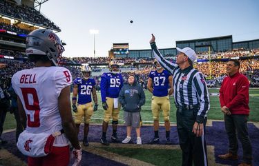 Referee Mark Duddy tosses the ceremonial pregame coin into the air before Friday’s Apple Cup.  The Washington State Cougars played the Washington Huskies in the 2019 edition of the Apple Cup game at Husky Stadium in Seattle, WA Friday, November 29, 2019. 212245