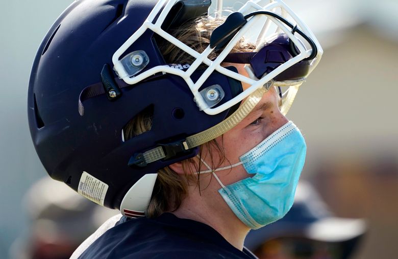 States wrestle with playing high school football amid COVID | The Seattle  Times