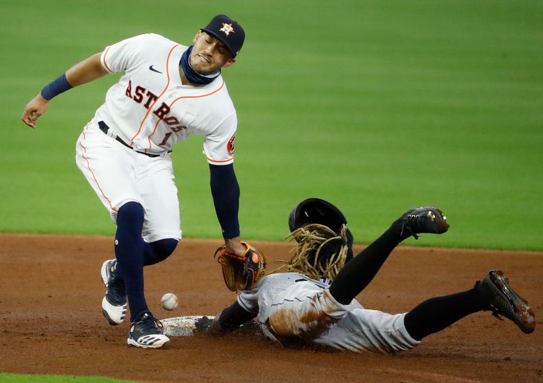 Houston Astros shortstop Carlos Correa throws to first base for