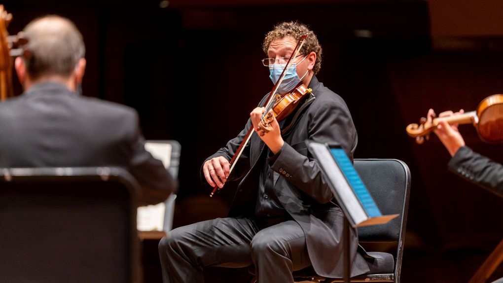 Seattle Symphony string players, including Concertmaster Noah Geller, rehearse for a season unlike any other. (James Holt / Seattle Symphony)