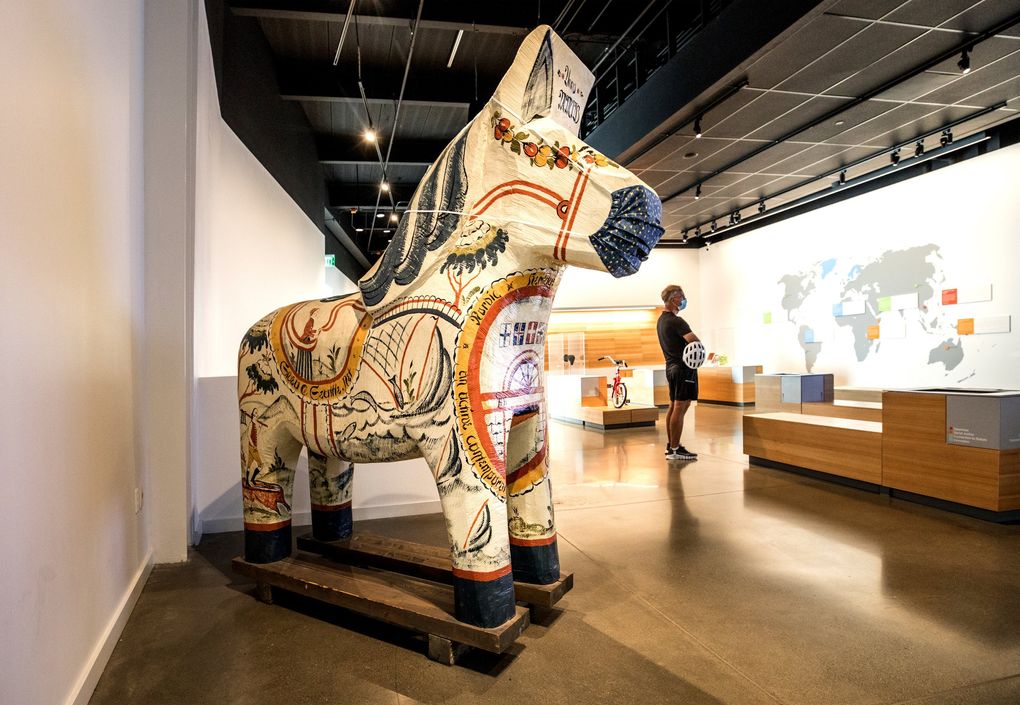 The National Nordic Museum reopened Sept. 4 with scheduled visits by the public. The sculpture Dala Horse by Birgitta Hedengren depicts landmarks, destinations and activities specific to Seattle and the Pacific Northwest. It’s located in the Nordic Perspectives Forum room. (Steve Ringman / The Seattle Times)