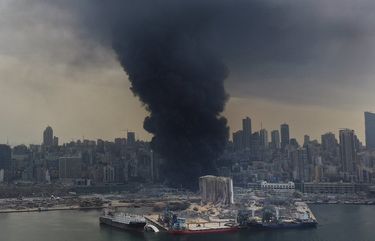 Black smoke rises from a fire at warehouses at the seaport of Beirut, Lebanon, Thursday, Sept. 10. 2020. A huge fire broke out Thursday at the Port of Beirut, triggering panic among residents traumatized by last month’s massive explosion that killed and injured thousands of people. (AP Photo/Hussein Malla) XHM104 XHM104