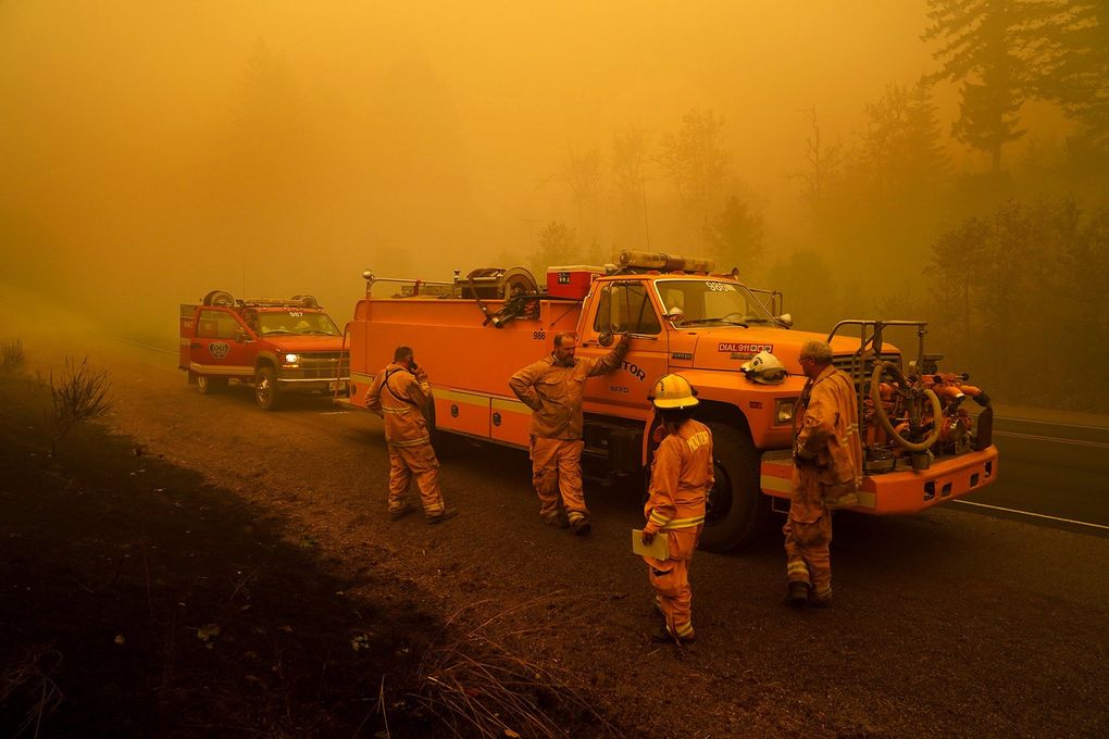 Firefighters with the Monitor Fire Department wait alongside the road surrounded by smoke in an area destroyed by a wildfire Saturday, Sept. 12, 2020, near Mill City, Ore. (AP Photo/John Locher) ORJL104 ORJL104 ORJL104 (John Locher / The Associated Press)