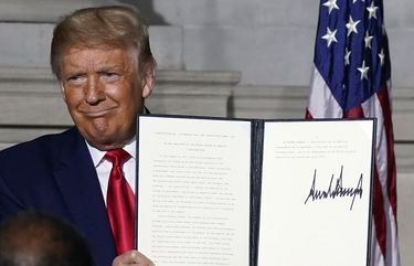 President Donald Trump holds a signed Constitution Day proclamation after he spoke to the White House conference on American History at the National Archives museum, Thursday, Sept. 17, 2020, in Washington. (AP Photo/Alex Brandon) DCAB318 DCAB318