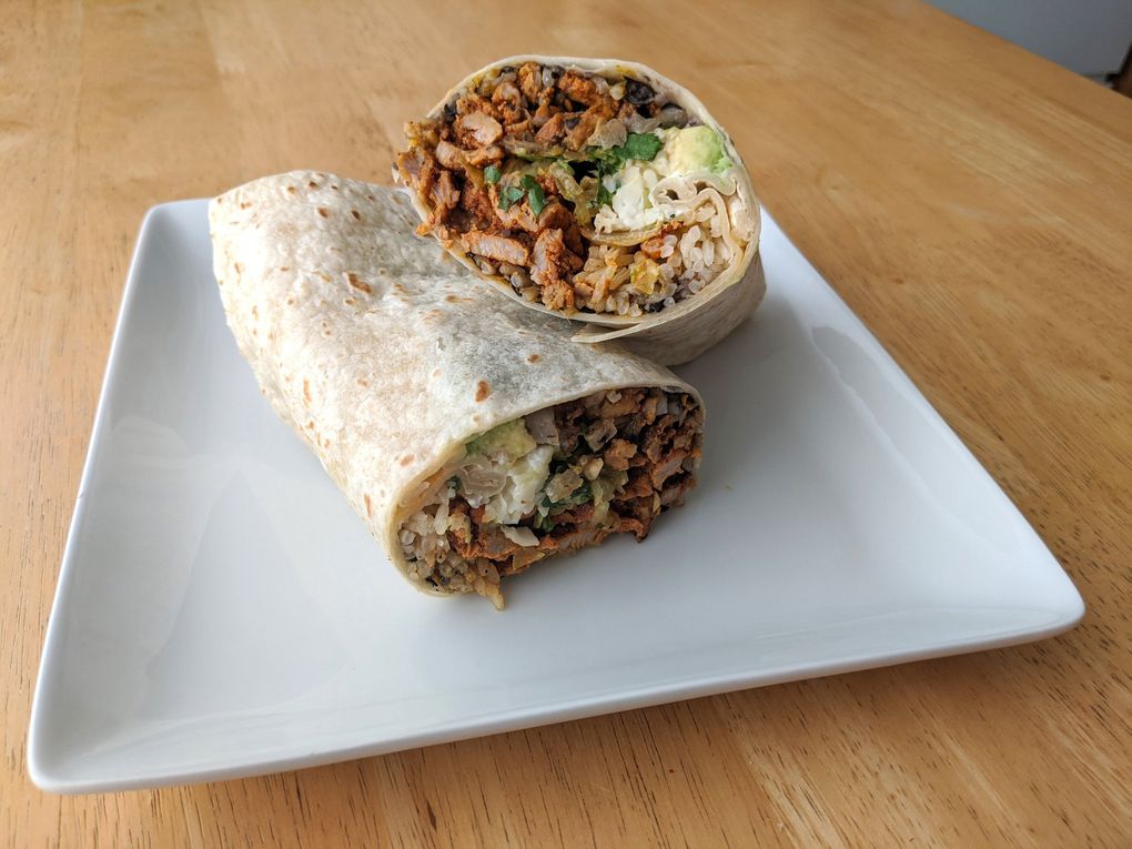 The big burrito at La Riviera Maya truly is massive, stuffed with black beans, rice, sour cream, avocado and your choice of meat. (Jackie Varriano / The Seattle Times)