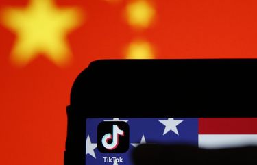 The TikTok app icon sits displayed on a smartphone in front the national flags of China and the U.S. in this arranged photograph in London, U.K., on Monday, Aug. 3, 2020. TikTok has become a flash point among rising U.S.-China tensions in recent months as U.S. politicians raised concerns that parent company ByteDance Ltd. could be compelled to hand over American users’ data to Beijing or use the app to influence the 165 million Americans, and more than 2 billion users globally, who have downloaded it. Photographer: Hollie Adams/Bloomberg 775542103