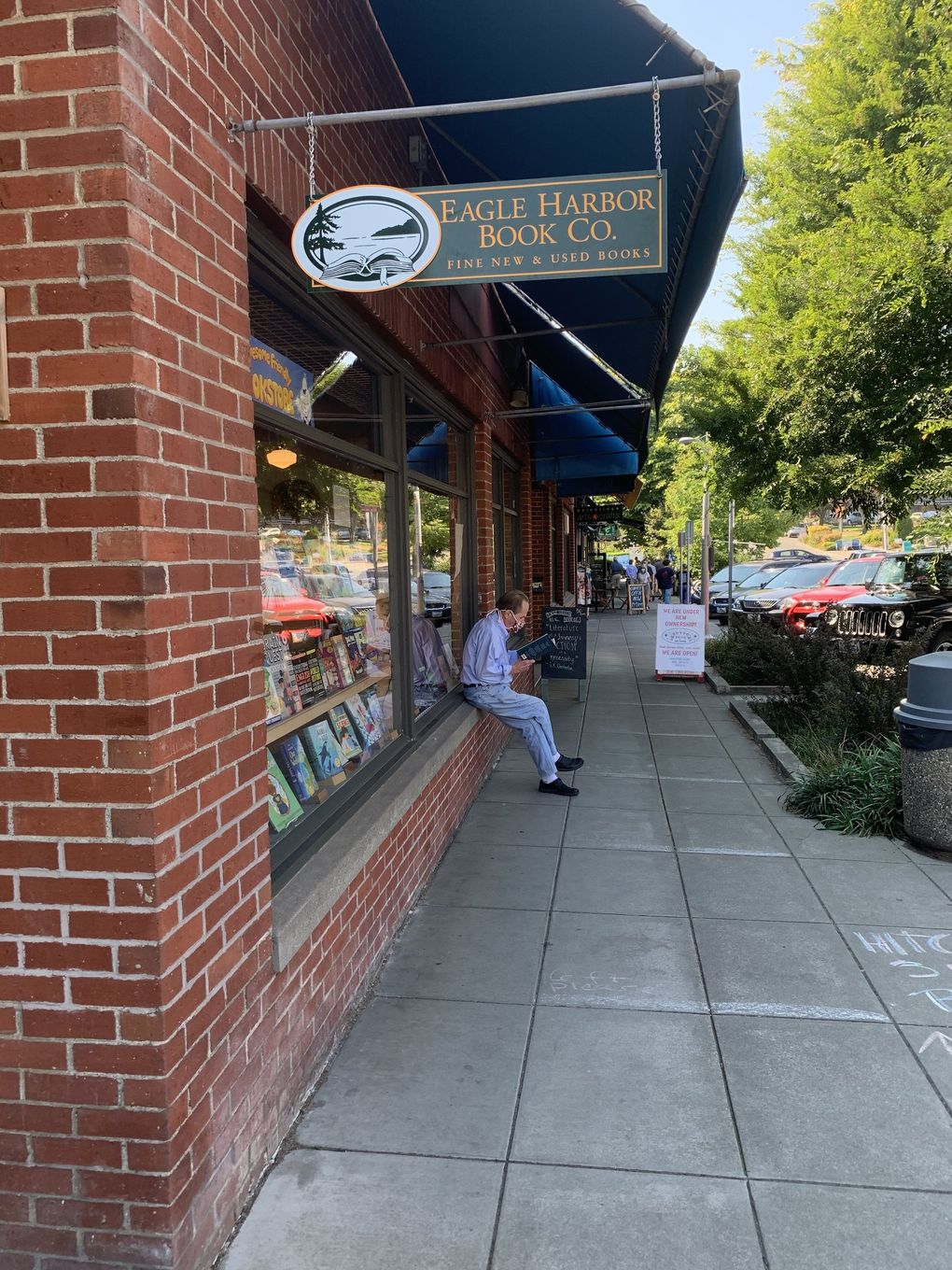 Leland Jones reads outside Eagle Harbor Book Company, a Bainbridge Island community staple for a half-century as of this month. (Courtesy of Eagle Harbor Books)