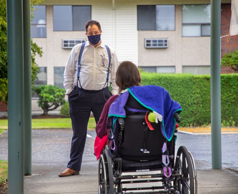Abraham Ritter visits with his mother, Patty Ritter outside the Enumclaw Health and Rehabilitation Center on Friday September 18, 2020. Ritter, who’s mother has been at the facility since 2004, has had concerns about staffing levels and his mother’s care.  215082 (Mike Siegel / The Seattle Times)