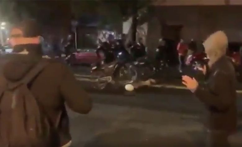 A screen-grab from a video shows a Seattle police officer wheel a bike’s tires over the head of a person lying in the road during a protest on Capitol Hill Wednesday night. (Courtesy of Joey Wieser)