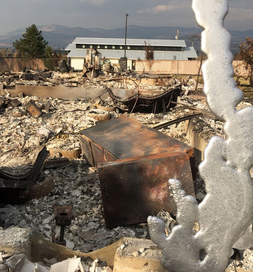 Scott Balcom saved this melted piece of aluminum as a symbol of renewal. He surmises the aluminum came from a car caught in the fire’s fierce heat. (Hal Bernton / The Seattle Times)