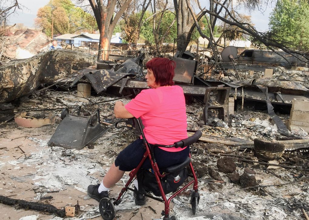 Renee Durgin said she worked 32 years scrubbing floors at a nursing home to help pay for her 1979 two-bedroom mobile home. It was one more than 2,800 structures destroyed by the Almeda fire. She is shown here on Sept. Sep. 18 as she returns to survey what’s left. (Hal Bernton / The Seattle Times)