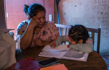 Miriam Flores works with children at a free day care she offers to single mothers who have nowhere to bring their children while schools were closed in Lima, Peru, on Aug. 12, 2020. Improvements in gender equality in the workplace may be another casualty of the coronavirus, as women find their place in the work force more at risk. (Marco Garro/The New York Times)