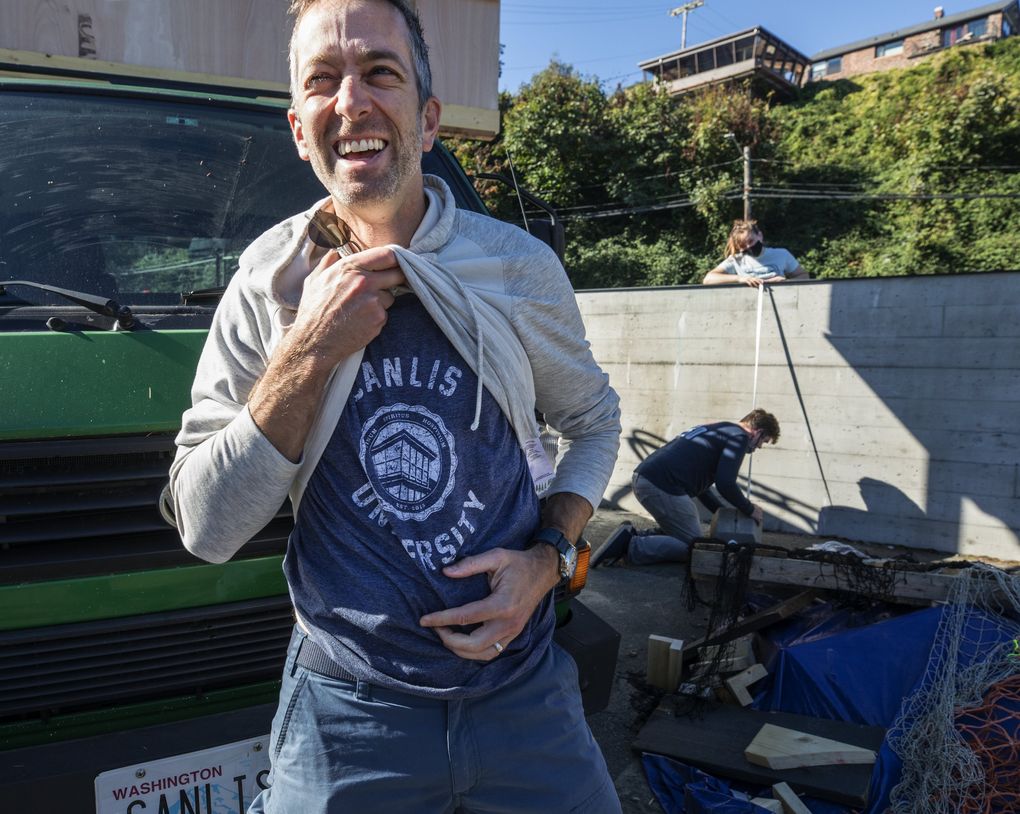 As work continues on the Canlis Community College Mark Canlis shows off his Canlis University T-shirt.
(Steve Ringman / The Seattle Times)