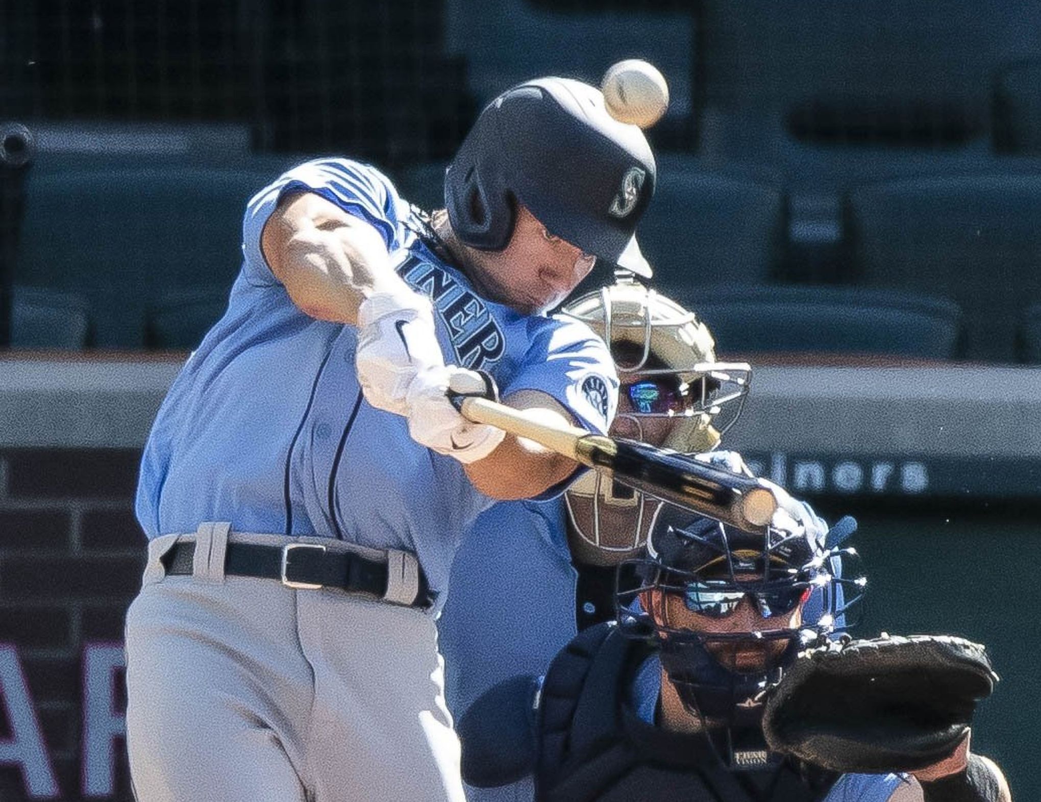 Seattle Mariners' Jarred Kelenic holds his head after a collision