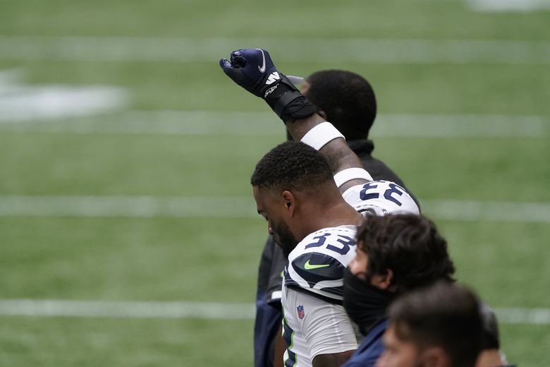 Falcons stand during both anthems; Seahawks protest