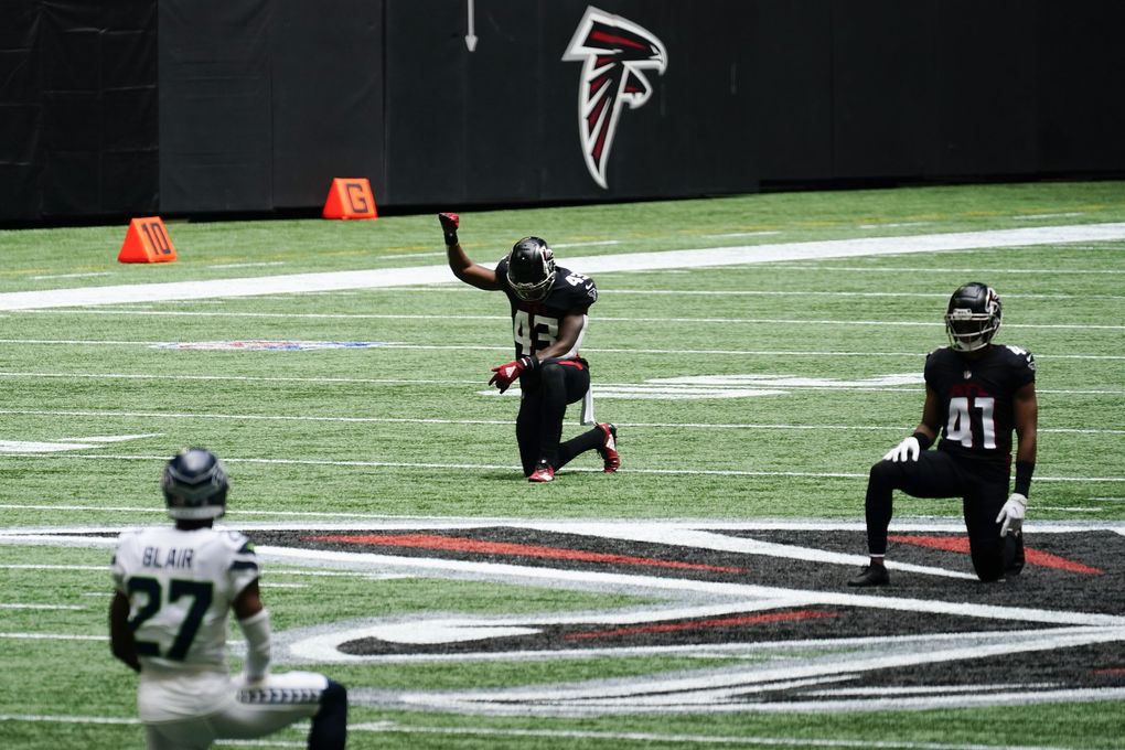 Players kneel in rememberance of Rep. John Lewis during the first half of an NFL football game between the Atlanta Falcons and the Seattle Seahawks, Sunday, Sept. 13, 2020, in Atlanta. (AP Photo/Brynn Anderson) GAMS112 GAMS112 (Brynn Anderson / The Associated Press)