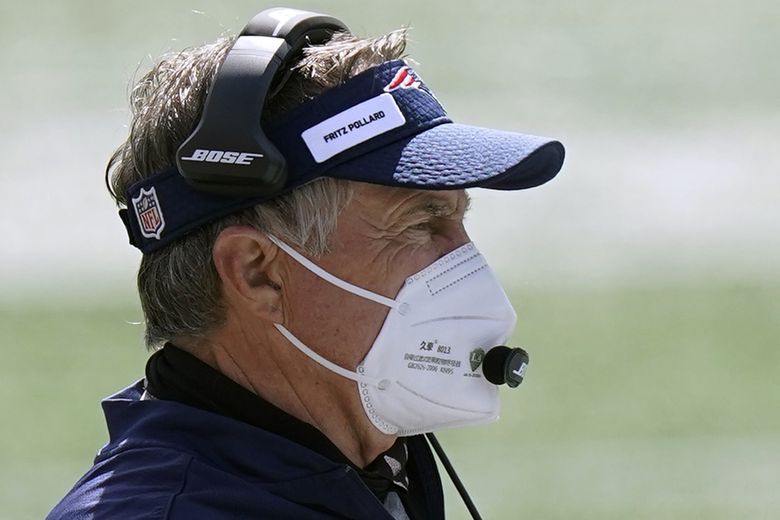 New England Patriots head coach Bill Belichick stands on the field