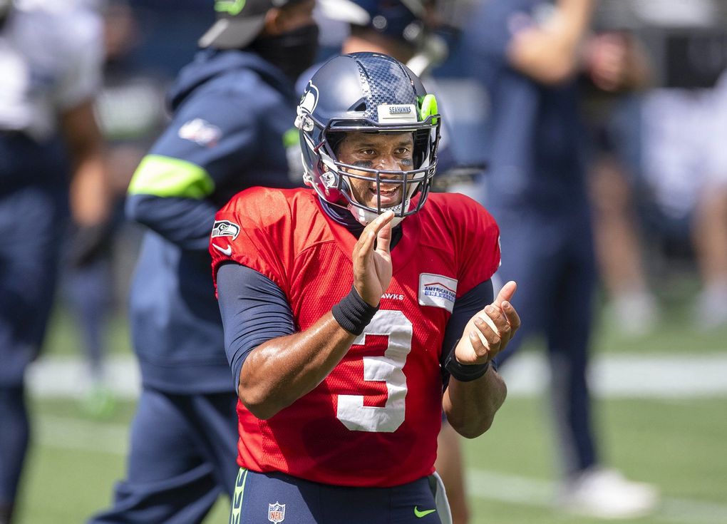 Russell Wilson helps the Seahawks psych up for their scrimmage Aug 22. (Dean Rutz / The Seattle Times)