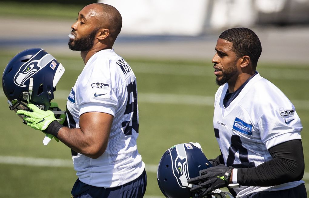Seahawks veteran linebackers K.J. Wright, left, and Bobby Wagner take the field at training camp Aug. 13. (Bettina Hansen / The Seattle Times)